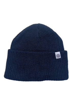 Navy blue beanie with a white logo tag on a white background